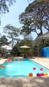a swimming pool with colorful balls in the water at Estância 7 praias in São Paulo +10 photos