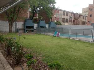 a yard with a fence and a swimming pool at La casa de Emma in Córdoba