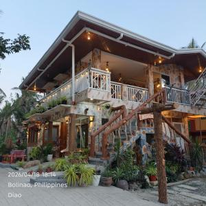 a house with a staircase in front of it at Farmhouse With Ocean View in Bolinao