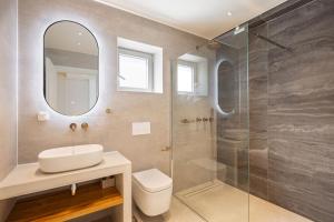 a bathroom with a sink and a shower at Kokkari Villa in Kokkari +19 photos