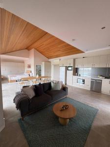 a living room with a couch and a table at Wonnerup Beach Manor in Wonnerup