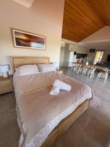 a bedroom with a large bed and a living room at Wonnerup Beach Manor in Wonnerup +47 photos