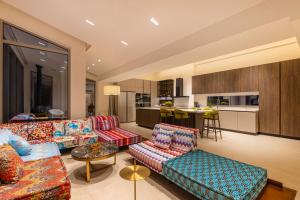 a living room with two couches and a kitchen at Kokkari Villa in Kokkari
