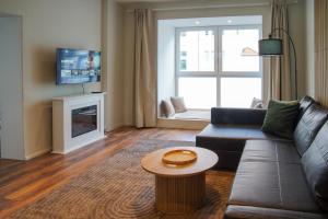 a living room with a couch and a table at Bielefeld Grand Central Residence in Bielefeld