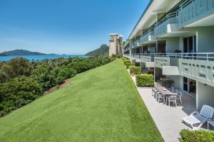 anterior view of a building with a green lawn at Poinciana 106 in Hamilton Island