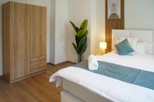 a bedroom with a large bed and a cabinet at Bielefeld Grand Central Residence in Bielefeld