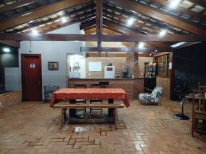 a large room with a table and a kitchen at Hostel Terraço Urbano in Sao Jose do Rio Preto