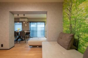 a living room with a couch and a dining room at PaPa's Resort 那須 in Nasushiobara