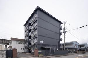 a large black building on the side of a street at PaPa's Resort 那須 in Nasushiobara