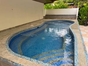 a swimming pool in the middle of a house at Hotel Manuel Antonio Park in Manuel Antonio