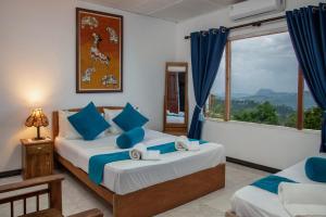a bedroom with two beds and a window at Bethel Rest Homestay in Kandy