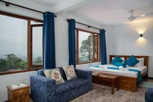 a bedroom with a bed and a couch and a chair at Bethel Rest Homestay in Kandy