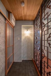 a hallway with a door and a wall of glass at PaPa's Resort 那須 in Nasushiobara +123 photos