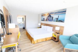 a hotel room with a bed and a desk at Days Inn by Wyndham Frankfort in Frankfort