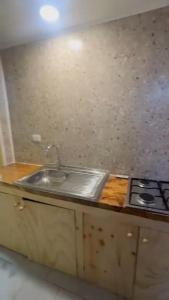 a kitchen with a sink and a stove at Lenayu in Pudeto
