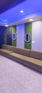 a long couch in a room with green walls at Madhav guest house in Agra +1 photo