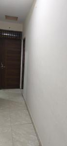 an empty room with a door and a wall at Madhav guest house in Agra