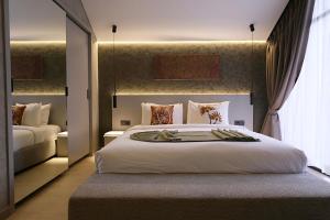 a bedroom with a large white bed and a window at SWOI LOFT UMALAs Designer 2BR Private Pool Villa in Kerobokan