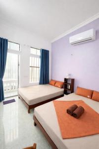 a hotel room with two beds and a window at An house Ninh Binh in Ninh Binh