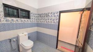 a bathroom with a toilet and a shower at Winter Bloom Homestay Munnar in Munnar +8 photos