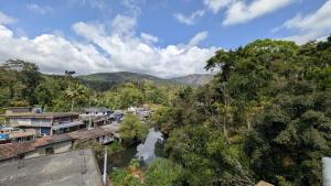 a river in a town with mountains in the background at Winter Bloom Homestay Munnar in Munnar