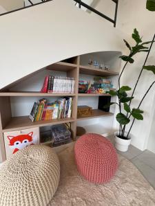 a living room with a book shelf with books at 八樂宿 包棟民宿 in Sanxing