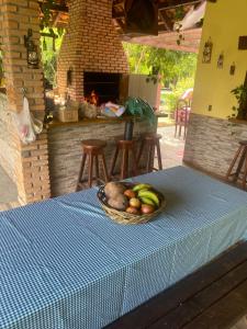 a bowl of fruit sitting on a table with a table cloth at Rancho ABA DO BETIONE in Bodoquena