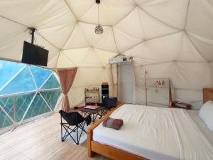 a bedroom with a bed in a tent at Glamping Dome Kusumanagara 2 in Bandung
