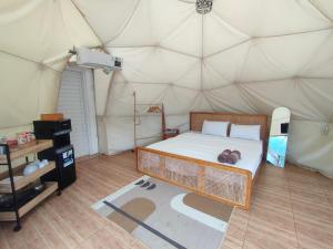 a bedroom with a bed in a tent at Glamping Dome Kusumanagara 2 in Bandung +4 photos