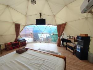 a large room with a large window in a tent at Glamping Dome Kusumanagara 2 in Bandung