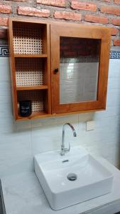 a bathroom with a sink and a wooden cabinet at Villa WENHOMANN View in Lovina +34 photos