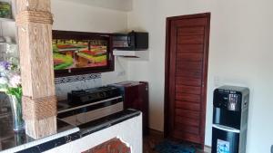a living room with a flat screen tv on a wall at Villa WENHOMANN View in Lovina