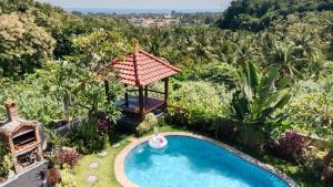 an overhead view of a pool in a garden with a gazebo at Villa WENHOMANN View in Lovina