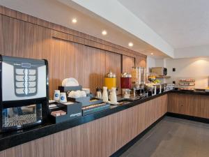 a buffet line in a hotel room with food at City Express by Marriott Santiago Aeropuerto in Santiago