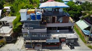 an overhead view of a house with two blue trash cans at Villaroman Inn in Baler