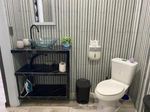 a bathroom with a toilet and a sink at Una Mirada al Atardecer in Pedregoso