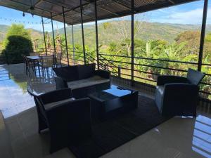 a patio with couches and tables and a view at Una Mirada al Atardecer in Pedregoso