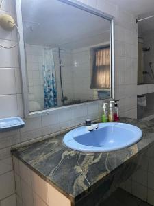 a bathroom with a sink and a mirror at MercuryFM 103 Guest House - Colombo 3 in Colombo