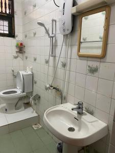 a bathroom with a sink and a toilet at MercuryFM 103 Guest House - Colombo 3 in Colombo +3 photos
