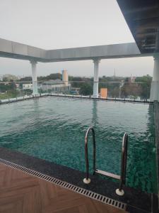 a swimming pool with two handles in the water at Sands Point Hotel in Pondicherry
