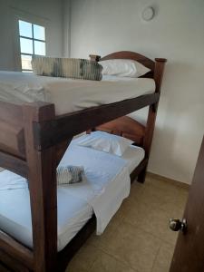 two bunk beds in a room with a door at Casa Vacacional in Tucacas