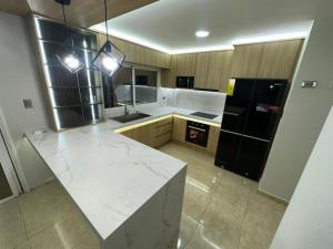 a kitchen with a white counter and a black refrigerator at Casa Vacacional in Tucacas