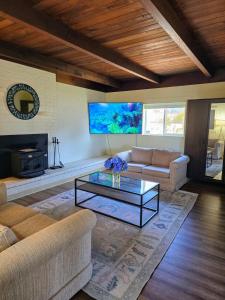 a living room with a couch and a coffee table at Ocean view-Huge backyard-Quiet neighborhood in Bodega Bay