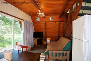 a living room with a refrigerator and a table at Park Motel and Cabins in Florence