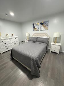 a bedroom with a large bed and two night stands at Chic & Comfy Apartment in Elizabethport