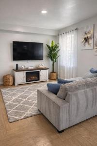 a living room with a couch and a tv at Chic & Comfy Apartment in Elizabethport