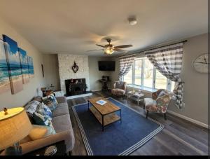 a living room with a couch and a table at Bay Front Manor House in Deale