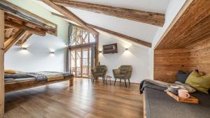 a room with two beds and two chairs at Ferienwohnung Schmickhof in Gaißach