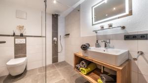 a bathroom with a sink and a toilet at Ferienwohnung Schmickhof in Gaißach +21 photos