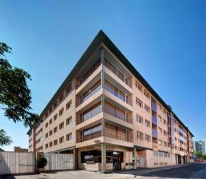 a large apartment building with a pointed roof at U Hotel Villa-Gomá in Zaragoza